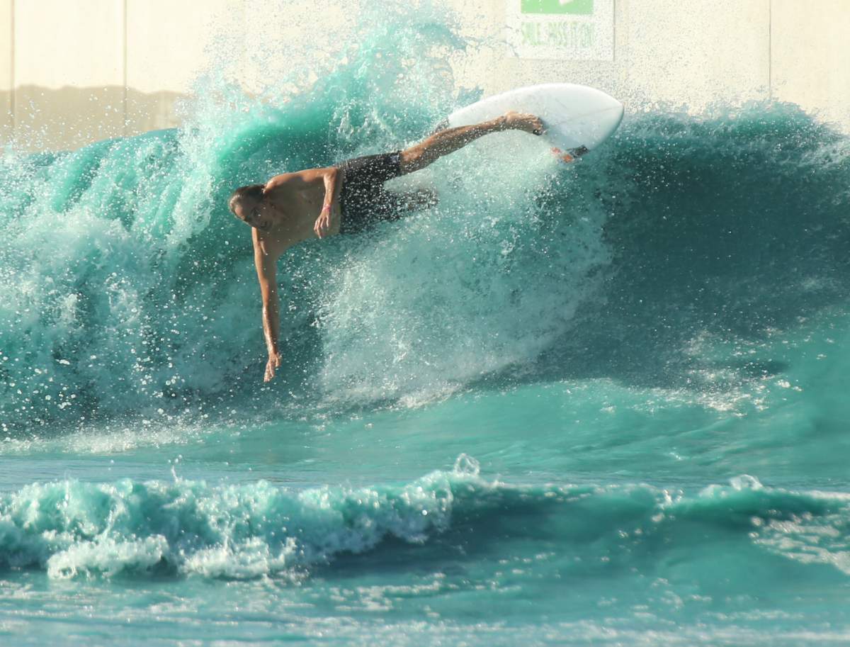 FILE - In this Saturday, July 14, photo-A surfer takes a spill while battling the waves at the BSR Surf resort near Waco, Texas.