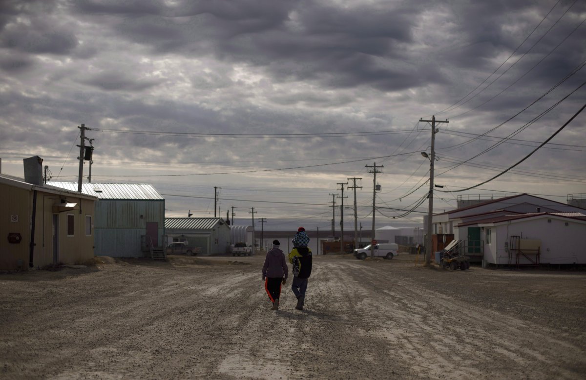 Three Arctic communities fear they've been cut off from crucial winter supplies after a government-owned company cancelled the annual supply barge that replenishes them. A family walks down the streets in Cambridge Bay, Nunavut, on Thursday, Aug. 31, 2017. Marine Transportation Services Ltd., owned by the Northwest Territories, says there's too much sea ice to run the scheduled barge to the central Arctic communities of Paulatuk, Kugluktuk and Cambridge Bay. 