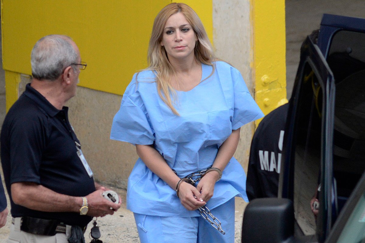 In this Sept. 24, 2015 photo, Aurea Vazquez Rijos, who was accused more than a decade ago of the murder of her husband, the Canadian Adam Anhang, is taken to the Federal Court in Hato Rey, Puerto Rico. Vazquez Rijos accused of hiring a hit man to kill her wealthy Canadian husband was found guilty on Wednesday, Oct. 2, 2018. 