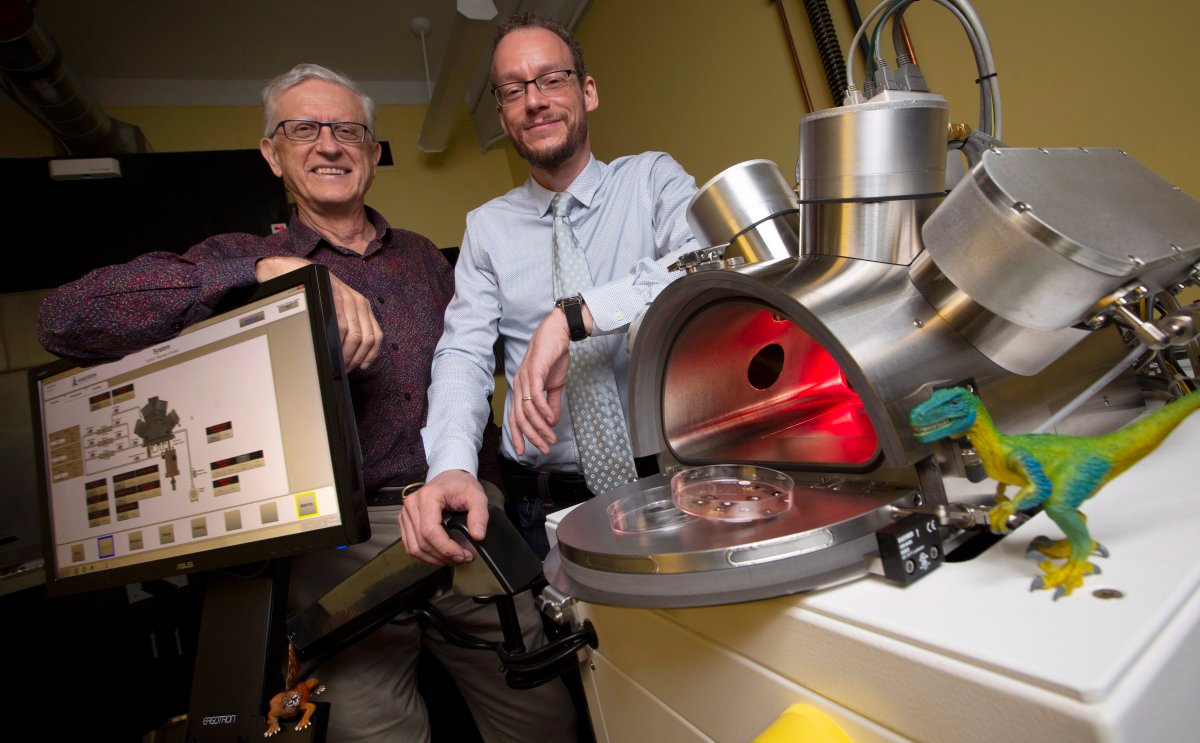 Professors Maikel Reinstadter, right, and Ralph Pudritz pose for a photo with the planet simulator in the origins of life lab at McMaster University in Hamilton, Ont., Wednesday, Oct. 3, 2018. 