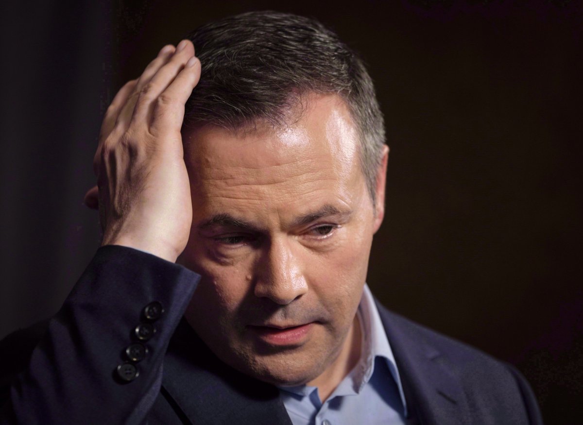 A United Conservative Party nomination candidate has been turfed after he and his fellow challengers were photographed with an anti-immigration group linked to neo-Nazis in Europe. Jason Kenney adjusts his hair as he speaks to the media at his first convention as leader of the United Conservative Party in Red Deer, Alta., Sunday, May 6, 2018. THE CANADIAN PRESS/Jeff McIntosh.