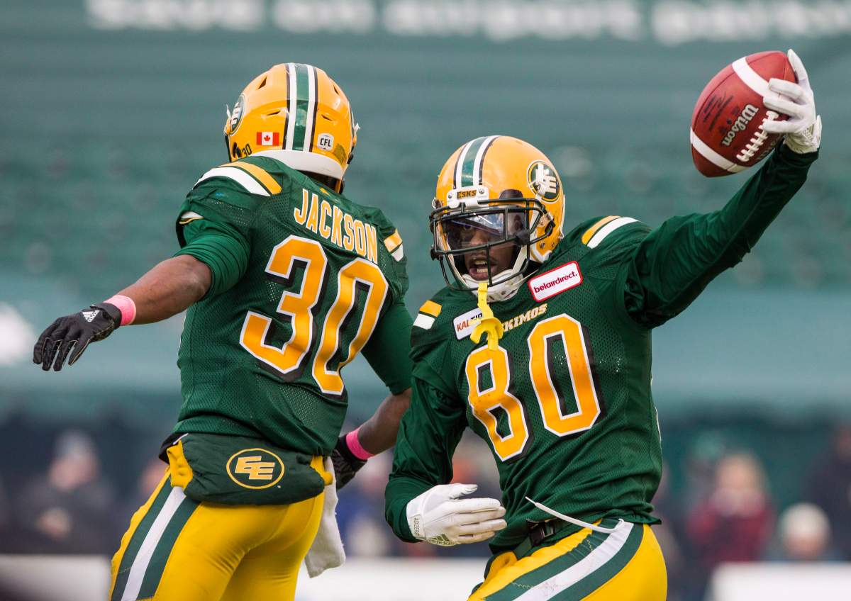Edmonton Eskimos' Bryant Mitchell (80) and Martese Jackson (30) celebrate Mitchell's 75 yard touchdown during second half CFL action against the Ottawa Redblacks, in Edmonton on Saturday, Oct. 13, 2018. 