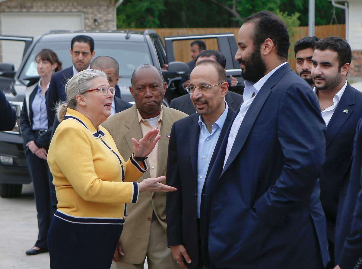 In this April 7, 2018, file photo, Saudi Crown Prince Mohammed bin Salman, right, is seen with his entourage as he tours a flood-damaged area in Houston, Texas. The man in the photo, rear second left, is allegedly the same individual in images that a pro-government Turkish newspaper published who was seen on surveillance video walking into the Saudi Consulate in Istanbul before writer Jamal Khashoggi vanished there.