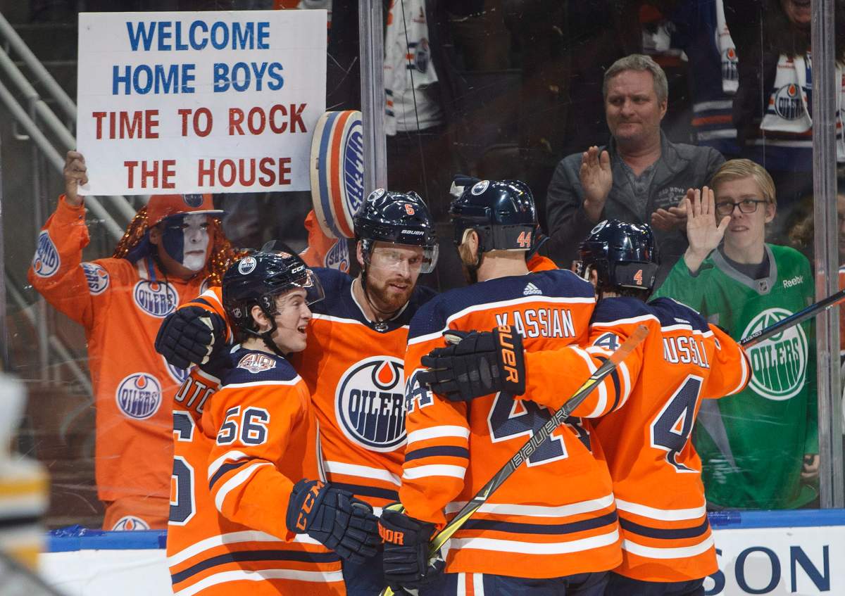 Edmonton Oilers' Kailer Yamamoto (56), Adam Larsson (6), Zack Kassian (44) and Kris Russell (4) celebrate a goal against the Boston Bruins during second period NHL action in Edmonton, Alta., on Thursday October 18, 2018. THE CANADIAN PRESS/Jason Franson.