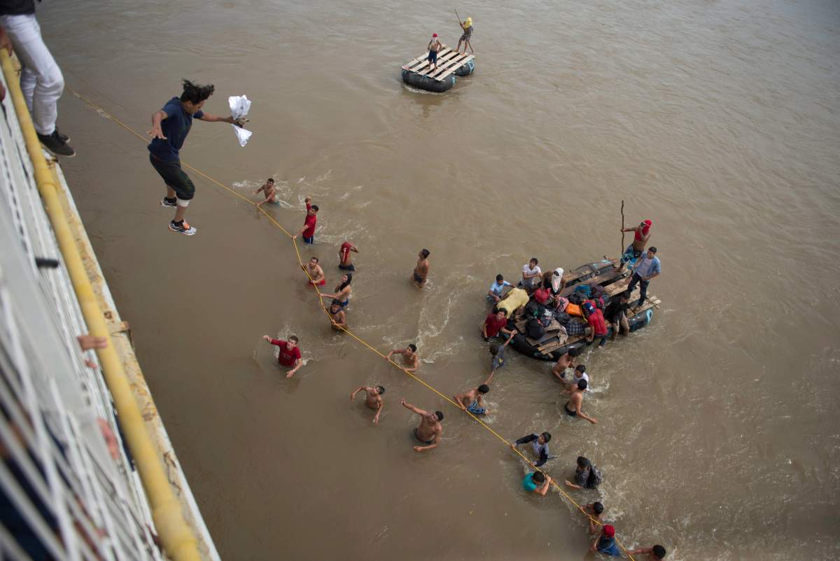 Migrants tired of waiting to cross into Mexico, jumped from a border bridge into the Suchiate River.