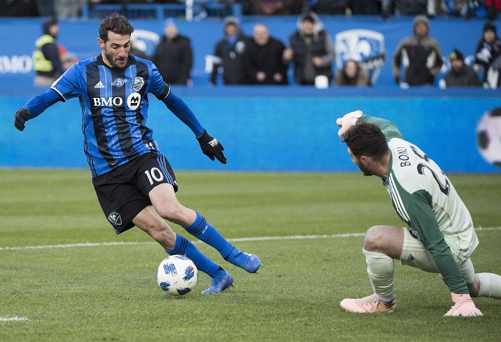 Montreal Impact's Ignacio Piatti moves in on Toronto FC's goalkeeper Alexander Bono during second half MLS soccer action in Montreal, Sunday, October 21, 2018. 