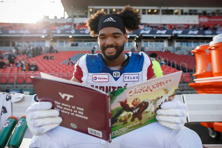 Montreal Alouettes defensive tackle Woody Baron (97) poses with his children's book on the sidelines in Toronto on Saturday, Oct. 20, 2018. 