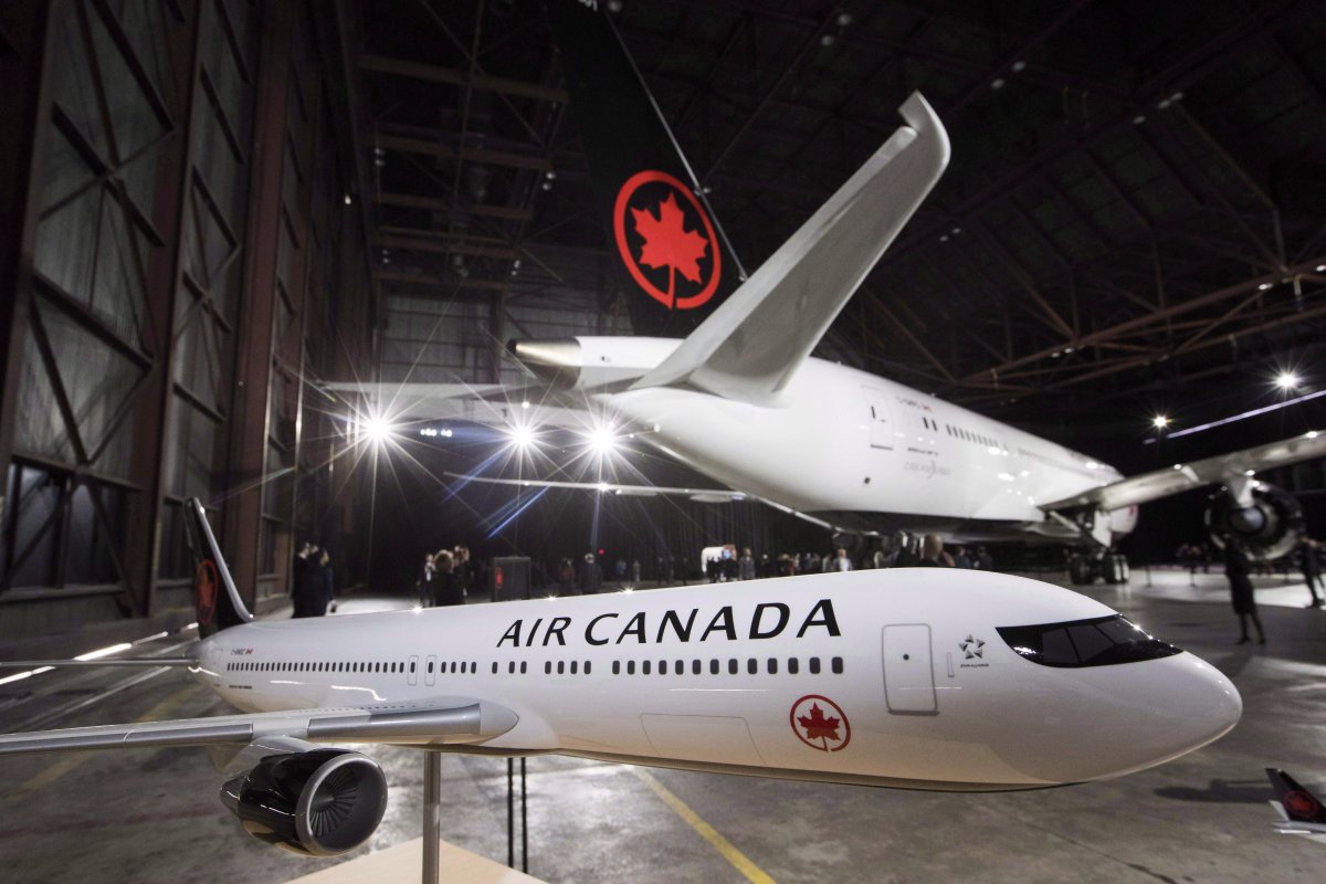 A model airplane is seen in front of the newly revealed Air Canada Boeing 787-8 Dreamliner aircraft at a hangar at the Toronto Pearson International Airport in Mississauga, Ont., on February 9, 2017. The Supreme Court of Canada has cleared the way for a class-action lawsuit against Air Canada and British Airways to proceed, dismissing an appeal by Canada's largest airline. Air Canada had sought to overturn an October 2017 Ontario Court of Appeal ruling that the class action could include foreign claimants despite playing out in Ontario courts. 