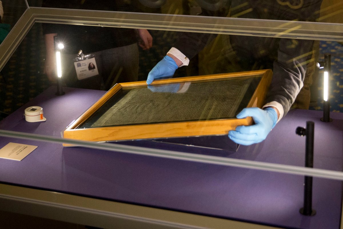 In this file photo dated Thursday, Feb. 5, 2015, The Salisbury Cathedral 1215 copy of the Magna Carta is installed in a glass display cabinet marking the 800th anniversary of the sealing of Magna Carta at Runnymede in 1215, in Salisbury, England.