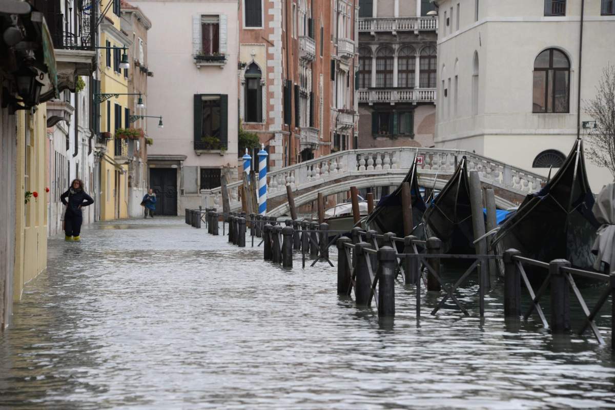 Tourists wander in high water in Venice, Italy, 29 October 2018.