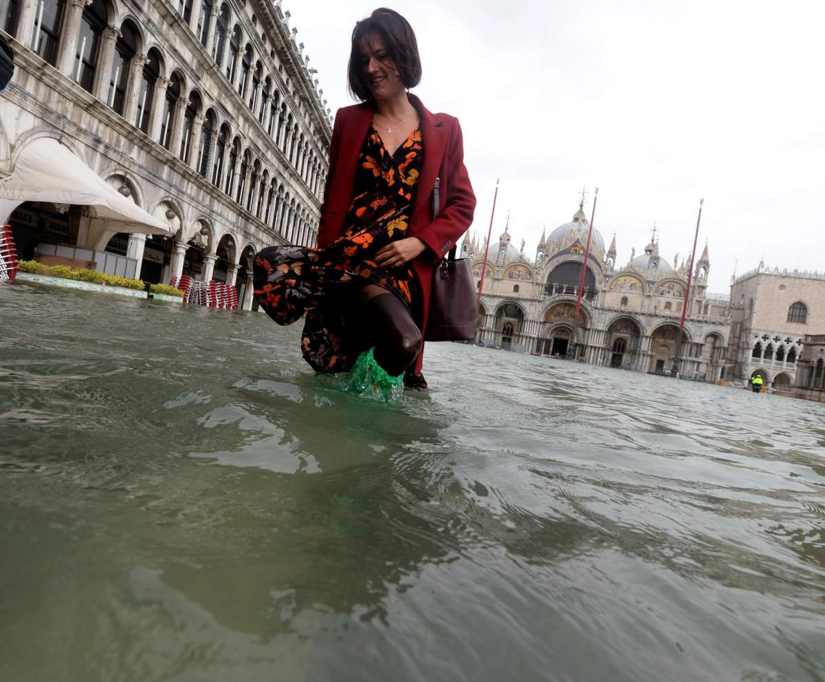 A tourist wanders in high water in Venice, Italy, 29 October 2018.