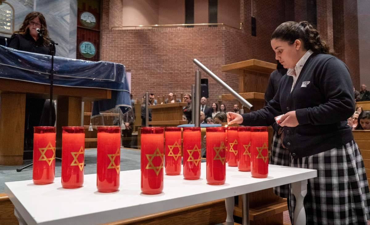 Candles are lit, one for each of the 11 victims, during a Montreal Jewish Community Memorial Vigil for the victims of the Pittsburgh synagogue attack in Montreal on Monday, Oct. 29 2018.