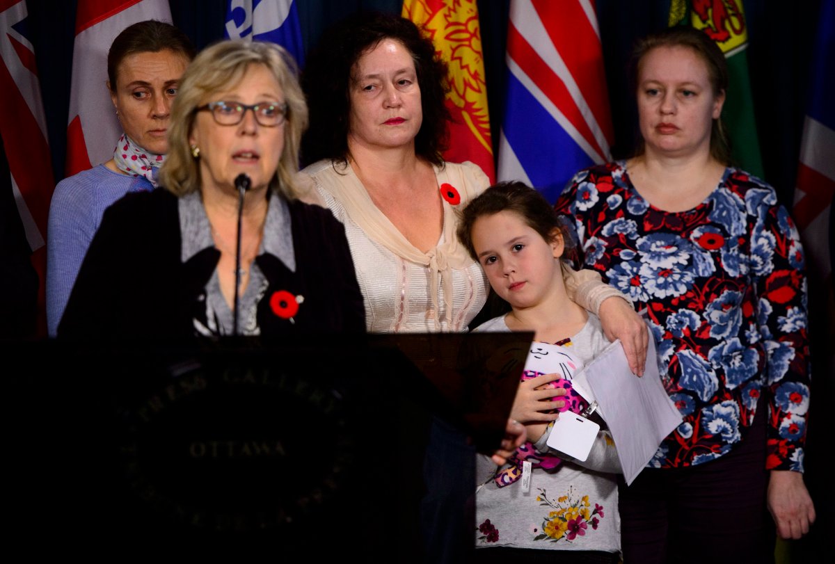 Elizabeth May, Leader of the Green Party, calls on the Government of Canada to urgently intervene in the case of Dr. Elena Musikhina, middle back, in Ottawa on Tuesday, Oct. 30, 2018.  