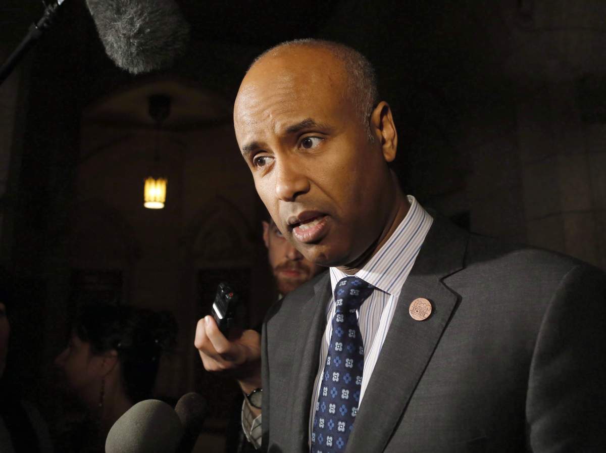 FILE - Minister of Immigration, Refugees and Citizenship Ahmed Hussen speaks to reporters outside the House of Commons on Parliament Hill on Thursday, May 31, 2018.