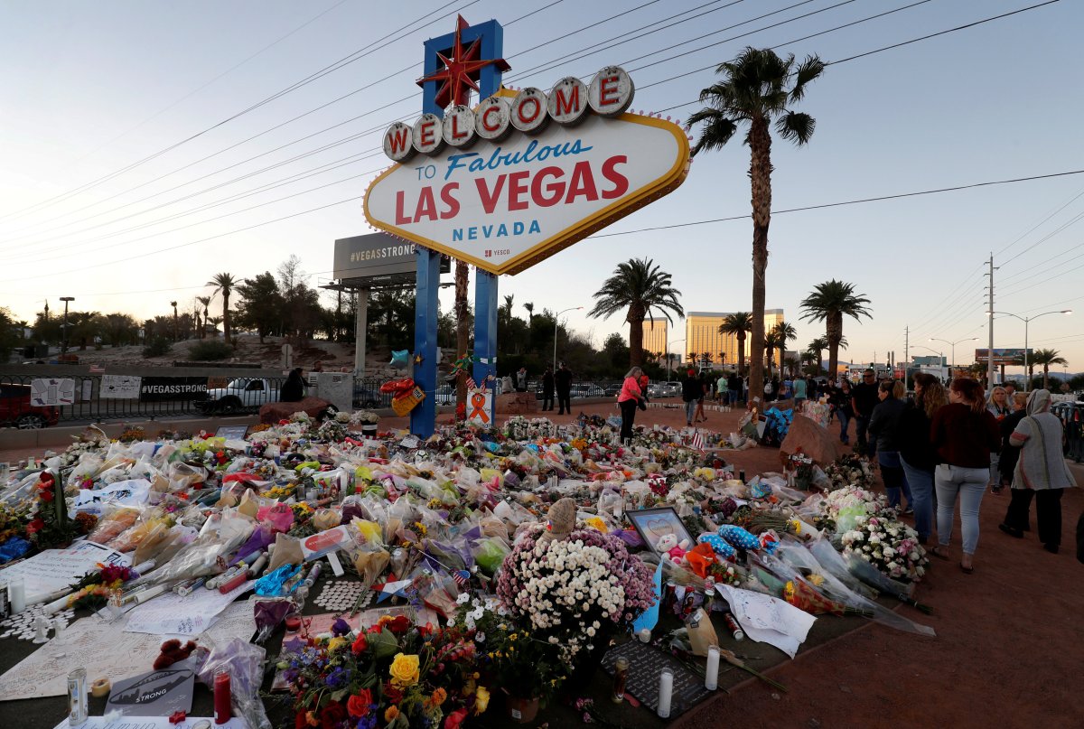 The "Welcome to Las Vegas" sign is surrounded by flowers and items, left after the October 1 mass shooting, in Las Vegas, Nevada, U.S. October 9, 2017.
