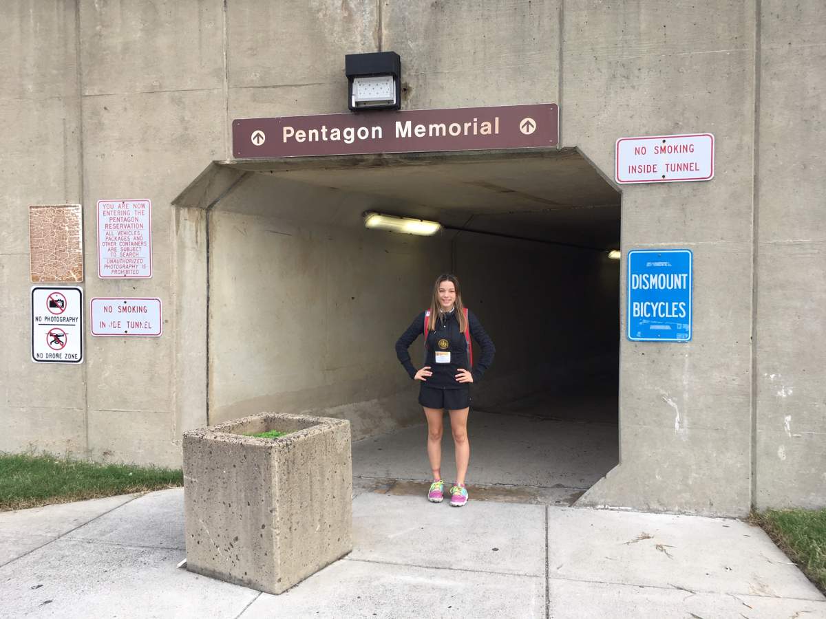 Deeanna Cowan stands in front of a sign to the entrance of the Pentagon Memorial. The 14-year-old was a camper at the International Burn Camp last week.