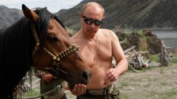 In this photo taken on Monday, Aug. 3, 2009, Russian Prime Minister Vladimir Putin seen feeding a horse in the mountains of the Siberian Tyva region (also referred to as Tuva), Russia, during his short vacation.