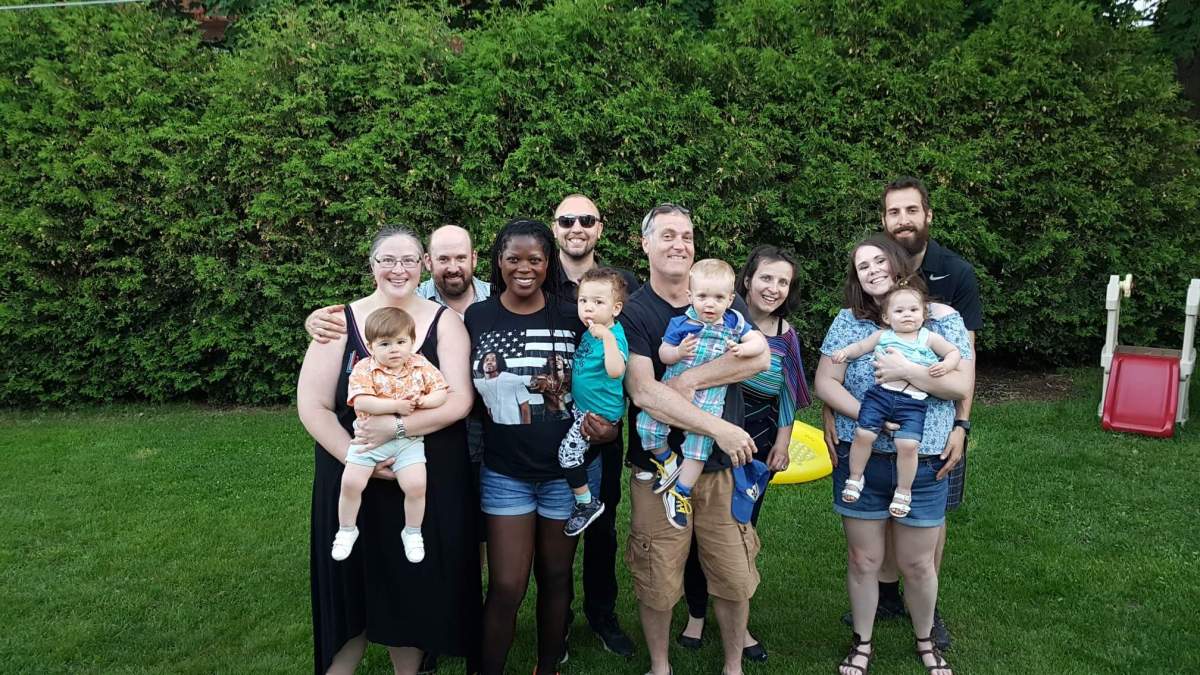 Meika Palmer (bottom row, second from the left) poses with her chosen family members.