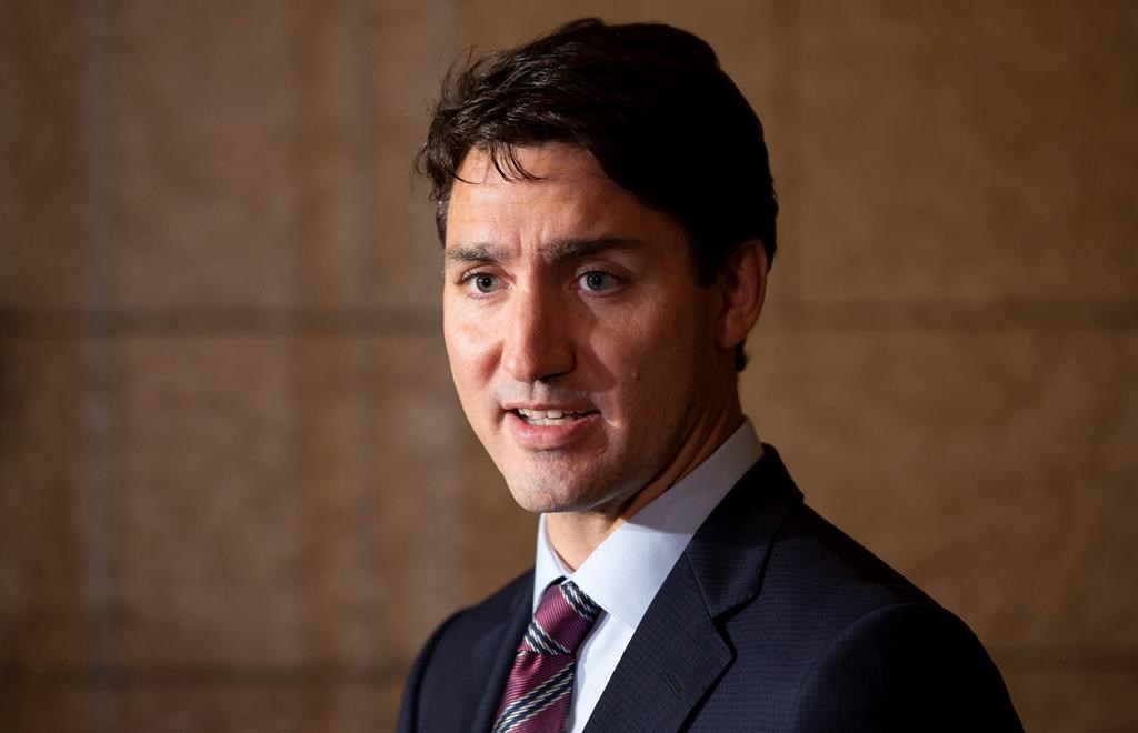 FILE - Canadian Prime Minister Justin Trudeau comments on the government's Trans Mountain Pipeline plan as he makes his way to caucus on Parliarment Hill in Ottawa, Wednesday, October 3, 2018.