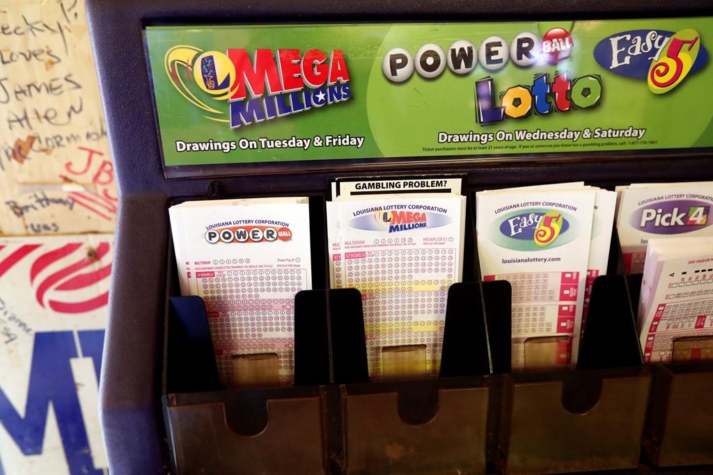 FILE - In this Tuesday, Oct. 23, 2018 file photo, lottery forms for Louisiana Mega Millions, Powerball and other lottery games fill the drawer at The World Bar and Grill, in Delta, La., a few miles from the Mississippi-Louisiana state line.