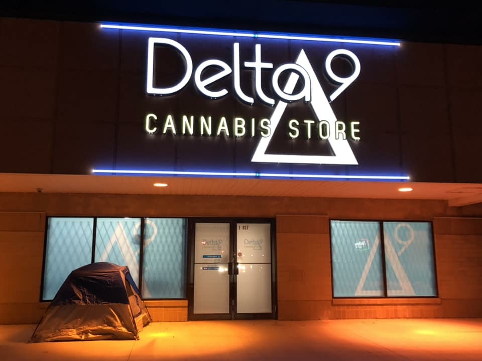 An excited camper sets up outside a cannabis store to wait for the first day of legal recreational sales.