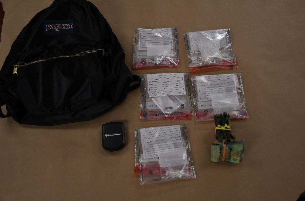 Police seized drugs, cash, scales, packaging, and a cellphone. 