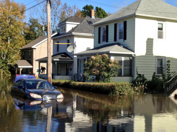 FILE - Water surrounds a home in Cape Breton during the October 2016 flooding.