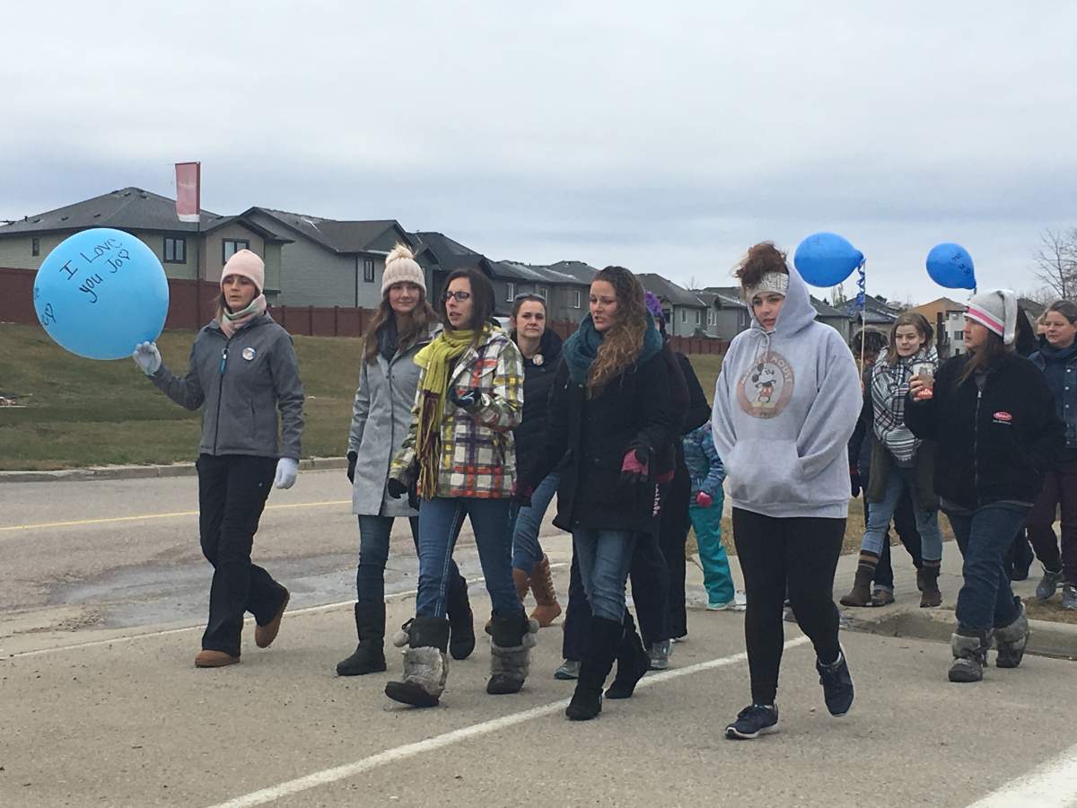 Jolene Cote’s family and friends walk through Spruce Grove, Alta. on Saturday, October 13, 2018.