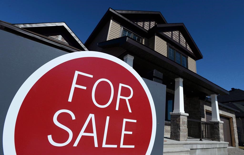 A sign advertises a new home for sale in Carleton Place, Ont., on March 17, 2015. Despite an easing in prices, the Canadian housing market remains "highly vulnerable," according to the Canadian Mortgage and Housing Corporation. THE CANADIAN PRESS/Sean Kilpatrick.