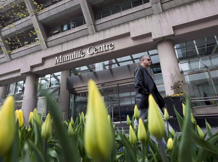 A man walks by the Manulife Centre in Toronto on the day of the Manulife Financial annual general meeting.