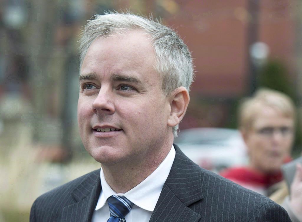 Dennis Oland heads from a bail hearing after being released from custody in Fredericton on Tuesday, Oct. 25, 2016.