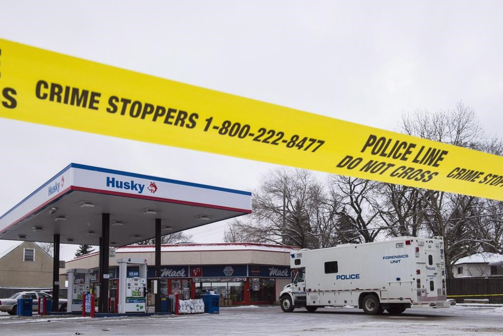 Homicide detectives investigate at a Mac's convenience store in Edmonton on December 18, 2015.