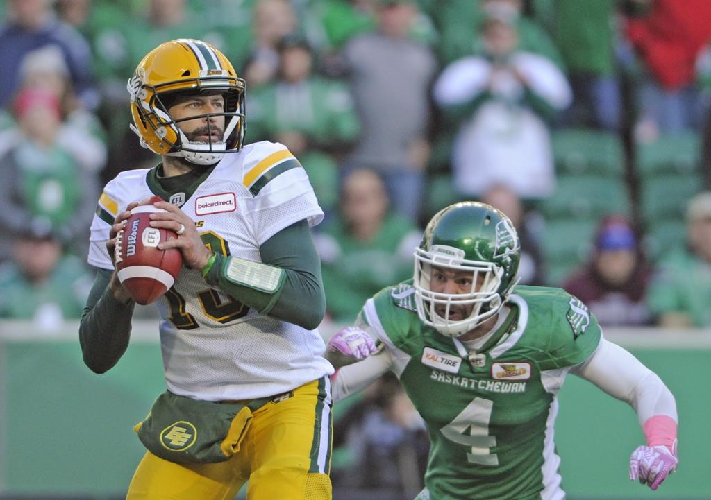 Saskatchewan Roughriders linebacker Cameron Judge gains on Edmonton Eskimos quarterback Mike Reilly before stripping the ball during second half CFL action in Regina on October 8, 2018.