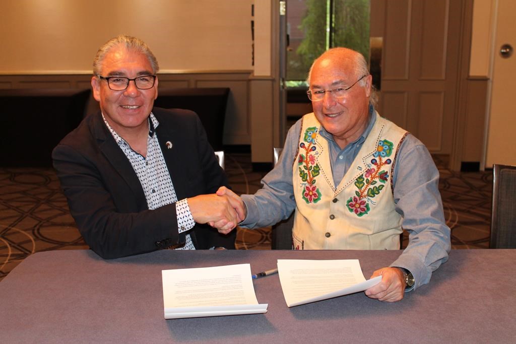 The Assembly of Nova Scotia Mi’kmaq Chiefs and the Metis National Council are pledging to work together on the growing number of people self-identifying as Metis, a trend both groups say is a concern. Glooscap First Nation Chief Sidney Peters, co-chairman of the Assembly of Nova Scotia Mi’kmaq Chiefs, and Clement Chartier, president of the Metis National Council, right, shake hands after signing a memorandum of understanding, in Halifax in a Wednesday, Oct. 3, 2018, handout photo.
