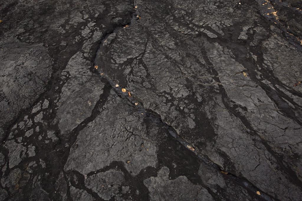 Bitumen in an open mine area is shown at the historic Bitumount oil sands mining, separating and refining facility in Fort McMurray Alta, on Tuesday October 5, 2016. A Calgary financial analyst says prices being paid for Western Canadian oilsands bitumen have fallen so far that producers are actually losing money on every barrel sold into the spot market. THE CANADIAN PRESS/Jason Franson.