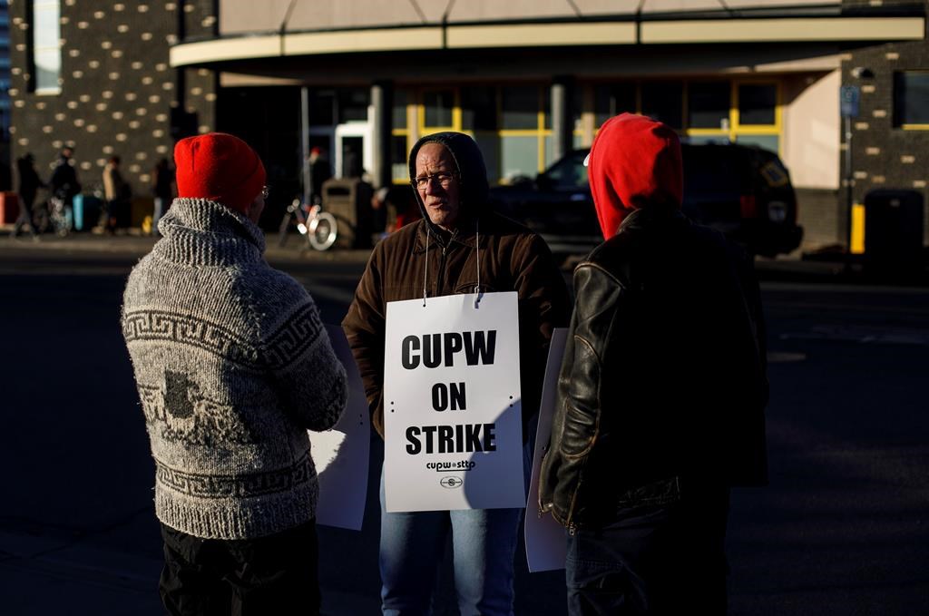Canada Post workers picket after going on strike in Edmonton, Alta., on Monday, October 22, 2018. THE CANADIAN PRESS/Jason Franson.