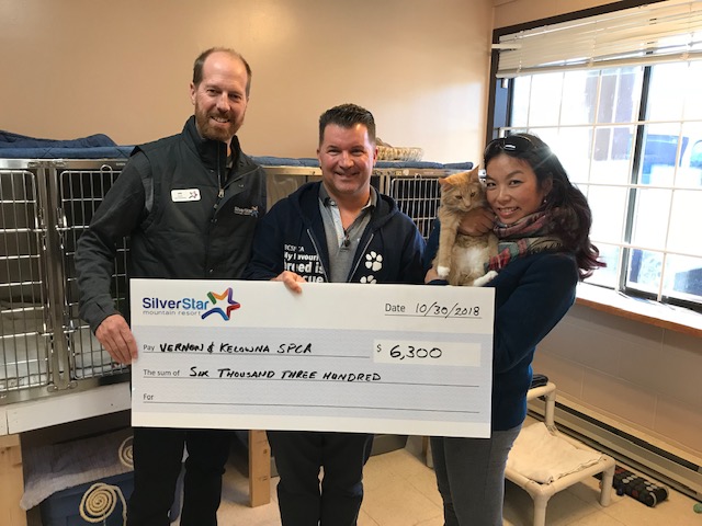Silver Star Mountain Resort's Wesla Wong and Ian Jenkins hand over a cheque for $6,300 to the BC SPCA.