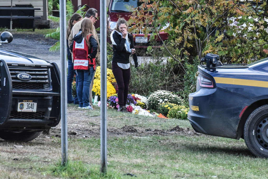 People mourn at the site of the fatal limousine crash on October 8, 2018 in Schoharie, New York. 20 people died in the crash including the driver of the limo, 17 passengers, and two pedestrians.