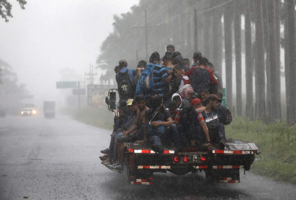 People in a migrant caravan make their way towards the Guatemalan border with Mexico on October 18, 2018, in Siquinala, Guatemala.