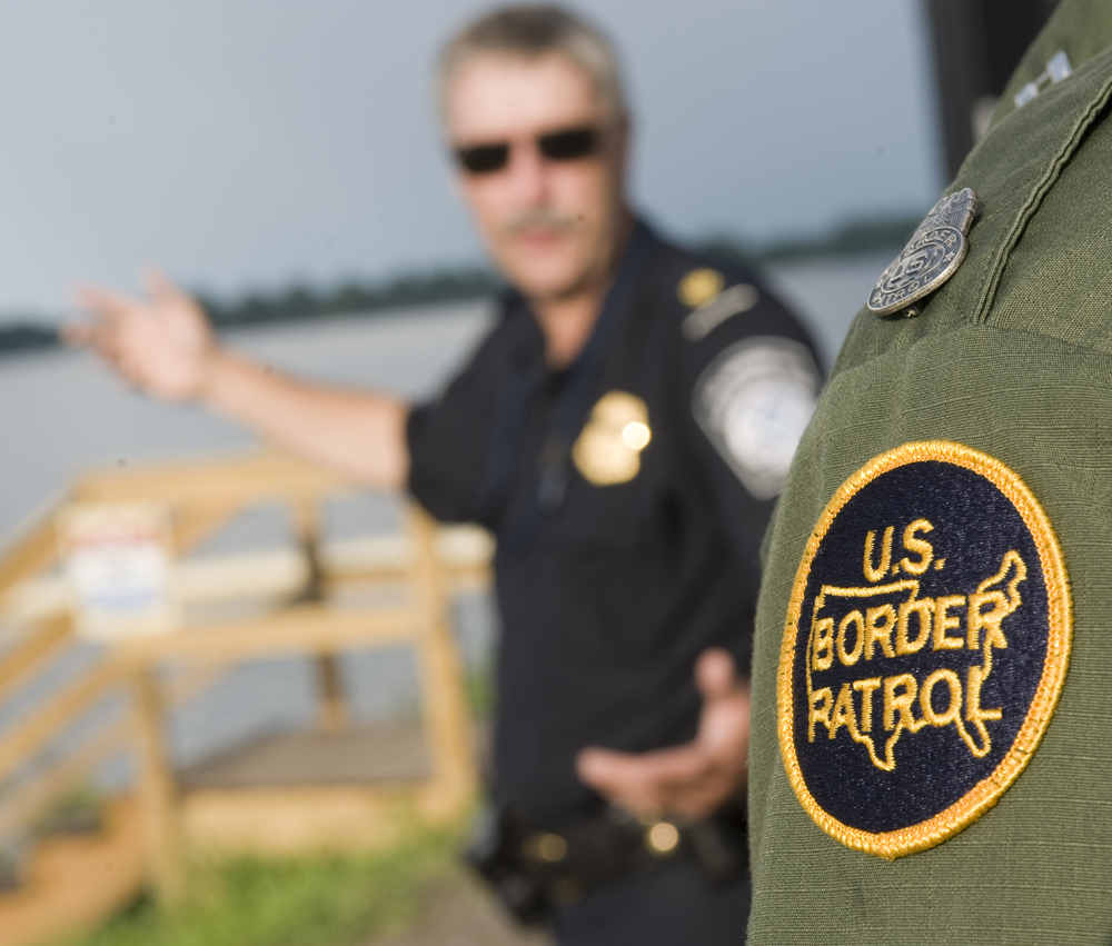 Supervisor Dan Moore of the Customs and Border Patrol agency speaks with Supervisor Richard Labounty of the US Border Patrol at a dock facility on Lake Champlain. 
