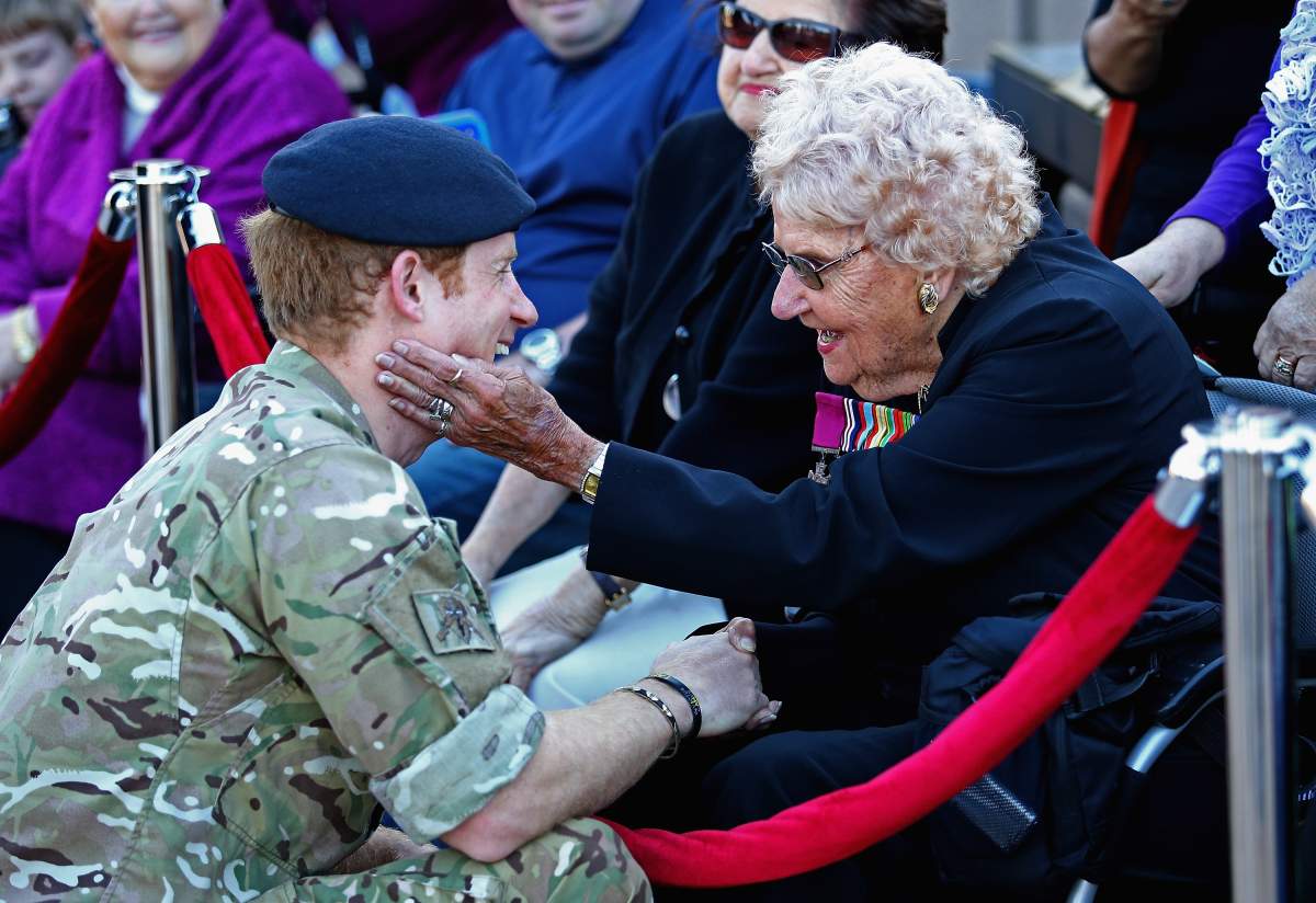 Prince Harry meets Daphne Dunne (wearing her husbands Victoria Cross) during a walkabout outside the Sydney Opera House on May 7, 2015 in Sydney, Australia.(Photo by Chris Jackson/Getty Images)