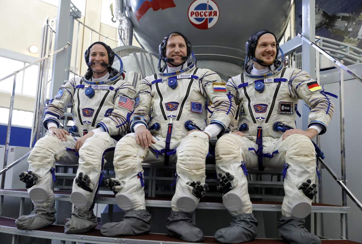 NASA astronaut Serena M. Aunon-Chancellor, Roscosmos cosmonaut Sergei Prokopyev, and ESA astronaut Alexander Gerst of the ISS Expedition 56/57 main crew in spacesuits.