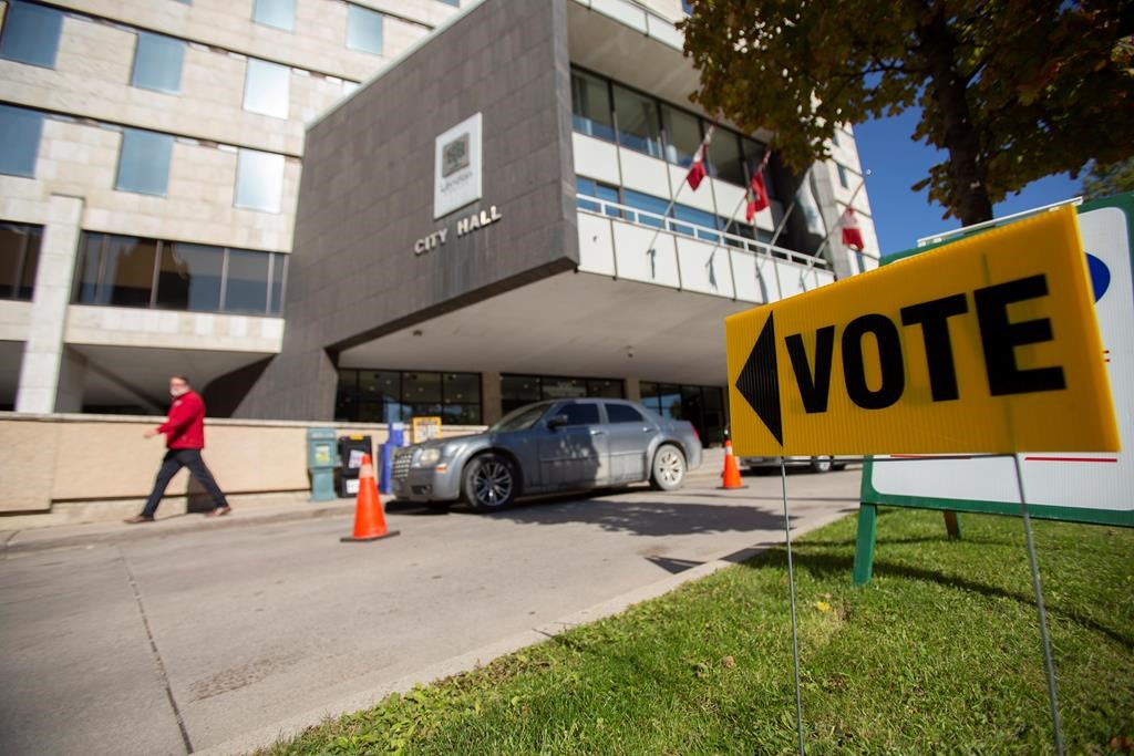 A sign points voters towards a polling station at City Hall in London, Ont., on Monday, October 22, 2018. London is the first municipality to adopt a ranked ballot system in Canada. THE CANADIAN PRESS/Geoff Robins.