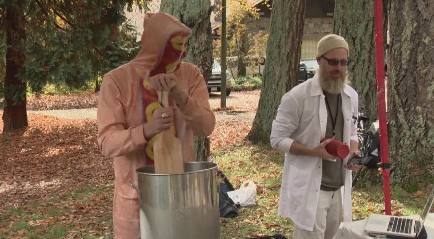 Artist Douglas Bevans stirs a pot of Hot Dog Water.