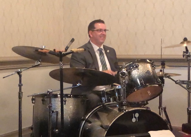 Cam Guthrie celebrates by playing the drums after being re-elected for a second term as mayor of Guelph.