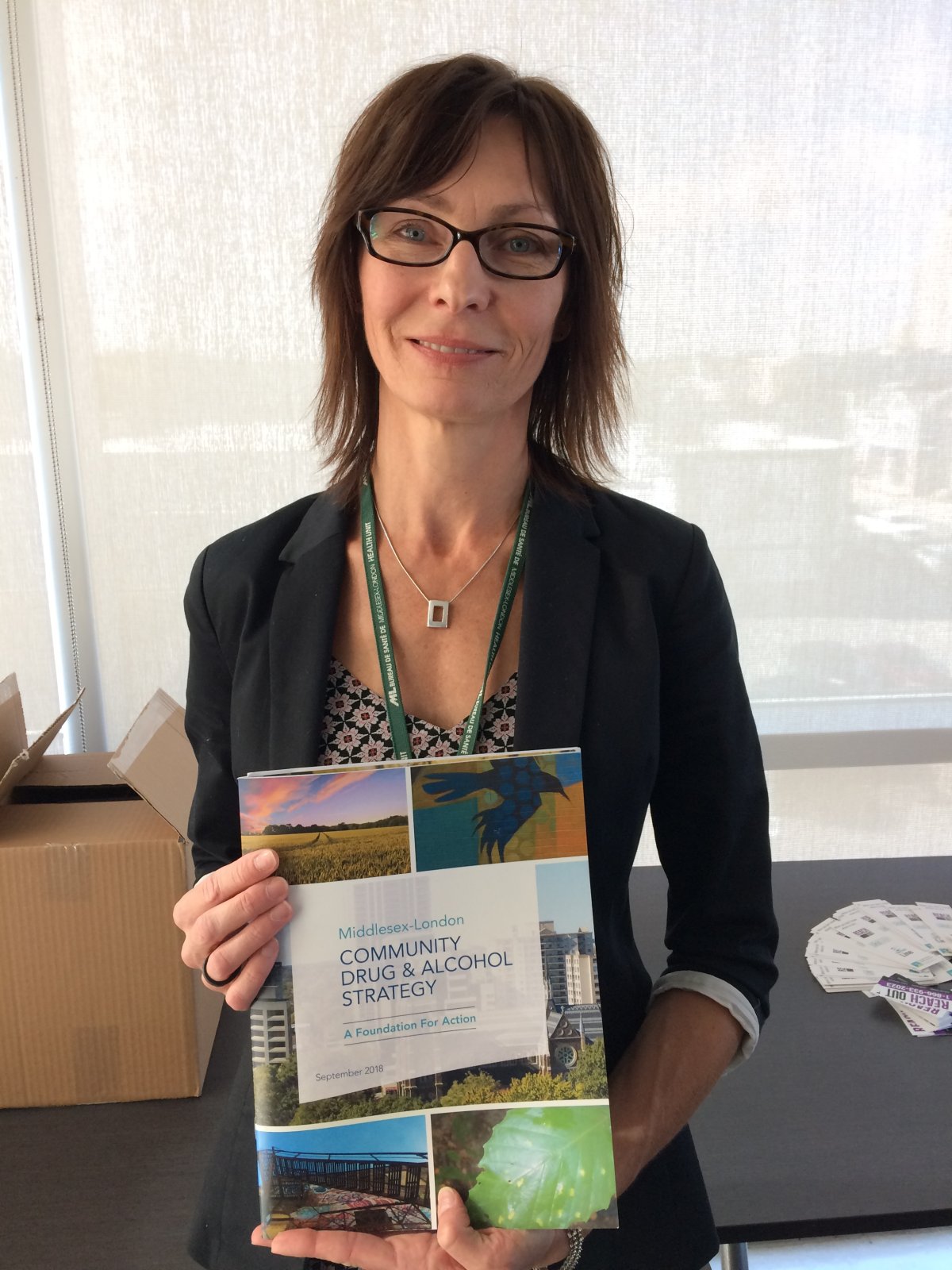 Co-chair of the CDAS steering committee Rhonda Brittan displays "The Middlesex-London Community Drug & Alcohol Strategy: A Foundation For Action" report, released Tuesday, Oct. 16, 2018 at Goodwill Industries on Horton Street in London. 