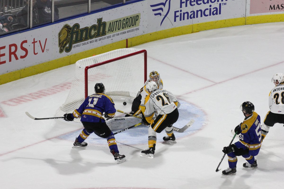 Connor McMichael of the London Knights puts the the puck past Aidan Hughes of the Sarnia Sting in a game played on Oct. 12, 2018, at Budweiser Gardens. 