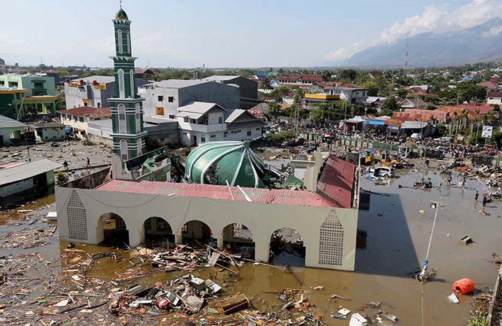 People survey the mosque damaged following earthquakes and tsunami in Palu, Central Sulawesi, Indonesia, Sept. 30, 2018.