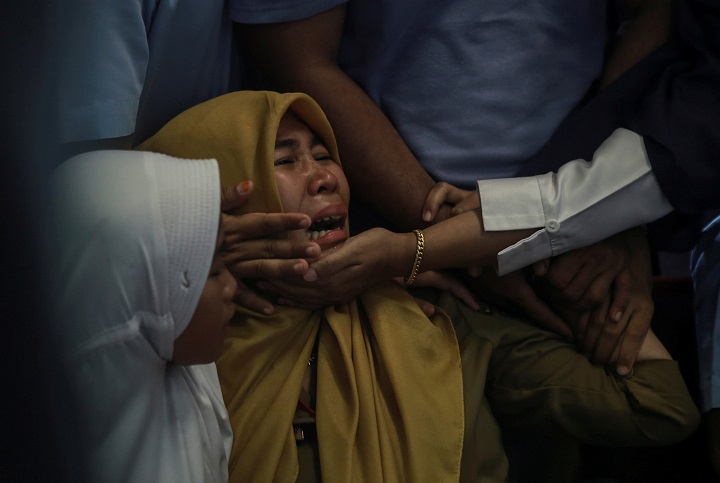 Relatives of passengers of Lion Air, flight JT610, that crashed into the sea cry at Depati Amir Airport in Pangkal Pinang, Belitung island, Indonesia, October 29, 2018.