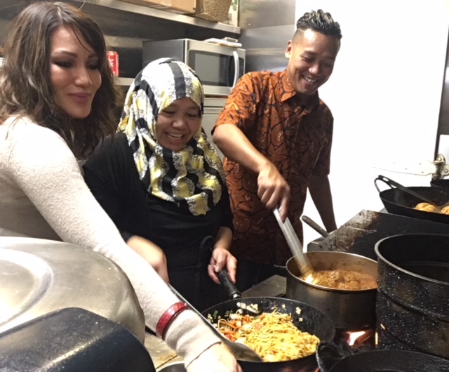 Kartini Castam, owner and chef of Indonesian Kitchen, cooking feast for fundraiser.